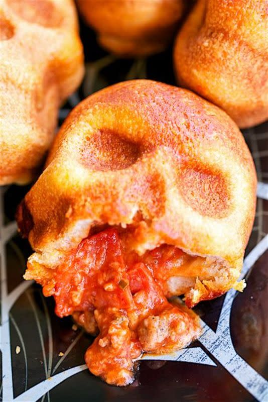 <p>Plain Chicken</p><p>Easy to customize, these pizza skills use refrigerated dough tucked into a skull cake pan and then use a variety of ingredients like pizza sauce, mozzarella and sausage. </p><p><strong>Get the recipe here: <a href="https://www.plainchicken.com/pizza-skulls/" rel="nofollow noopener" target="_blank" data-ylk="slk:Pizza Skulls;elm:context_link;itc:0;sec:content-canvas" class="link rapid-noclick-resp">Pizza Skulls</a></strong></p>