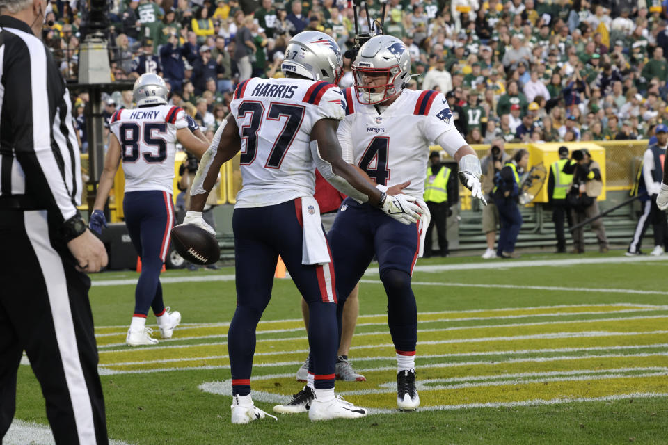 New England Patriots running back Damien Harris (37) celebrates with teammate quarterback Bailey Zappe (4) after scoring on a 5-yard touchdown run during the second half of an NFL football game against the Green Bay Packers, Sunday, Oct. 2, 2022, in Green Bay, Wis. (AP Photo/Mike Roemer)