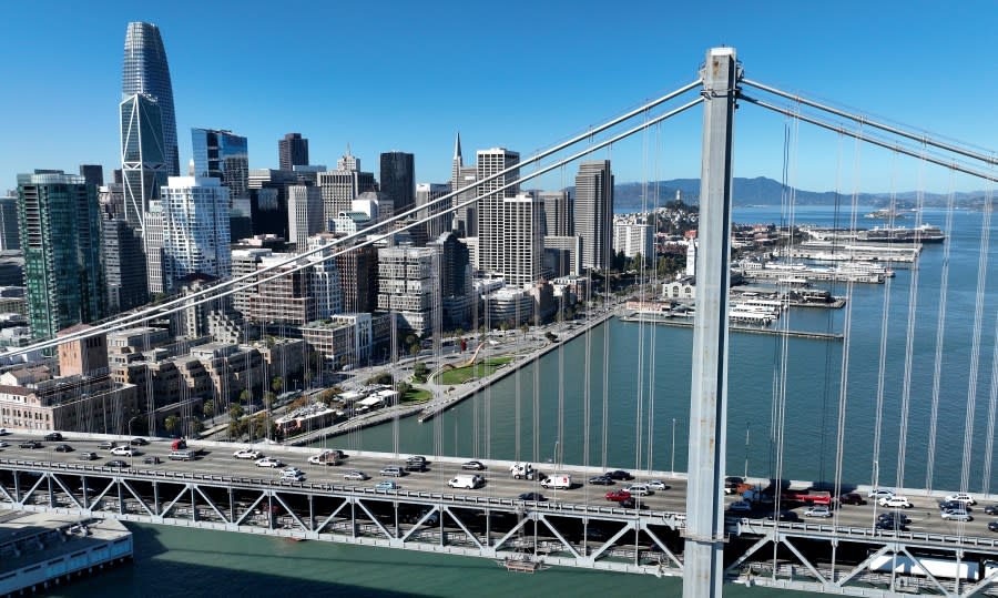 In an aerial view, cars drive by the San Francisco skyline as they cross the San Francisco-Oakland Bay Bridge on October 27, 2022. (Photo by Justin Sullivan/Getty Images)