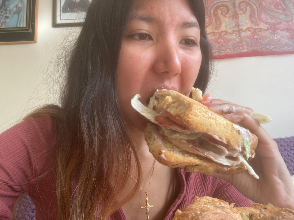 A picture of the author struggling to eat the sandwich.