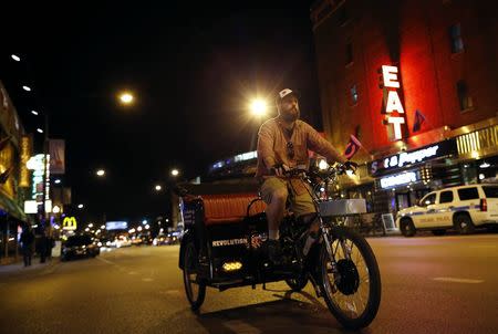 T.C. O'Rourke drives his pedicab in the Wrigleyville neighborhood in Chicago, Illinois, September 19, 2014. REUTERS/Jim Young