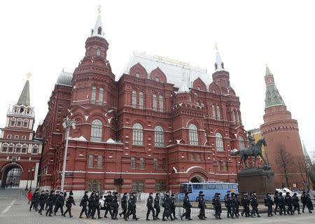 Policemen gather near the State Historical Museum and the Kremlin towers in the case of an anti-government protest, which was not sanctioned by the authorities, in central Moscow, Russia, April 2, 2017. REUTERS/Maxim Shemetov