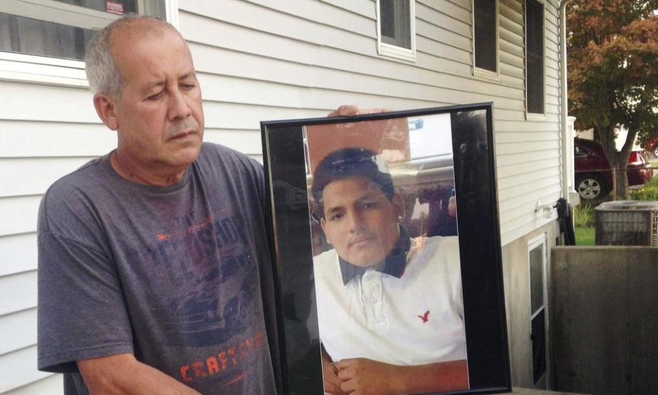 Abraham Chaparro with a photograph of his murdered stepson, Miguel Garcia-Moran, outside his home in Brentwood.