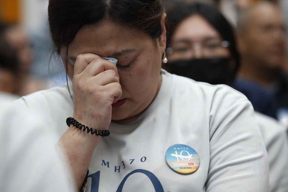 A family member of passengers on board of the missing Malaysia Airlines Flight 370 cries during the tenth annual remembrance event at a shopping mall, in Subang Jaya, on the outskirts of Kuala Lumpur, Malaysia, Sunday, March 3, 2024. Ten years ago, a Malaysia Airlines Flight 370, had disappeared March 8, 2014 while en route from Kuala Lumpur to Beijing with 239 people on board. (AP Photo/FL Wong)