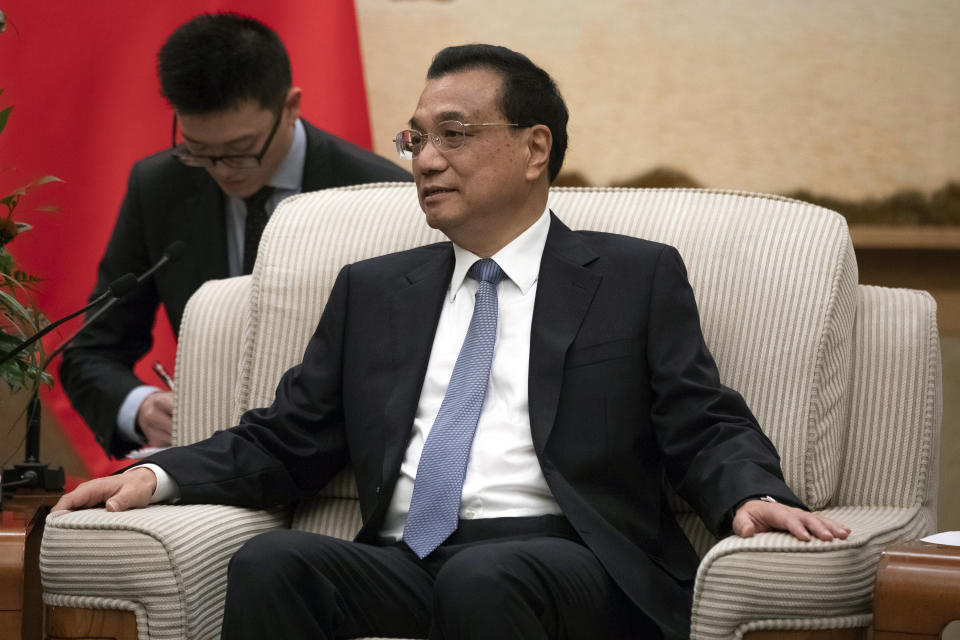 Chinese Premier Li Keqiang meets Japanese Prime Minister Shinzo Abe at the Great Hall of the People in Beijing, Thursday, Oct. 25, 2018. Abe arrived in Beijing on Thursday as both countries try to repair ties that have been riven by disputes over territory, military expansion in the Pacific and World War II history. (Roman Pilipey/Pool Photo via AP)