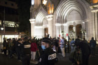 A policeman stands guard in front of the Notre Dame church in Nice, France, Friday, Oct. 30, 2020. A new suspect is in custody in the investigation into a gruesome attack by a Tunisian man who killed three people in a French church. France heightened its security alert amid religious and geopolitical tensions around cartoons mocking the Muslim prophet. (AP Photo/Daniel Cole)