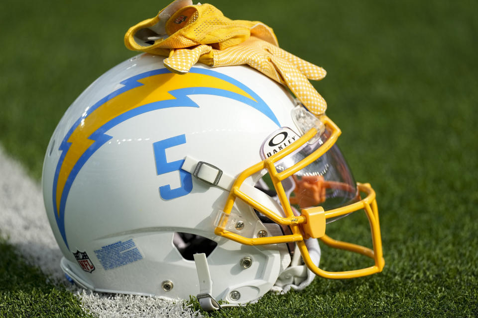 The helmet and gloves of Los Angeles Chargers wide receiver Joshua Palmer sits on the field before an NFL football game against the Kansas City Chiefs, Sunday, Jan. 7, 2024, in Inglewood, Calif. (AP Photo/Mark J. Terrill)