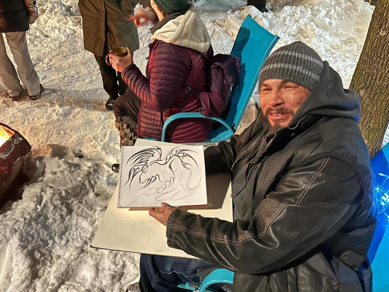 Daniel Joseph Charles McLaren holds up his drawing of a moose, which reminds him of his home community in northwestern Quebec. (Jessica Wu/CBC - image credit)