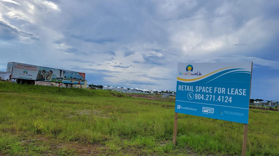 A sign and a semi-trailer advertise for Beachwalk, a developing community in St. Johns County, Florida, one of the nation's fastest growing coastal counties.