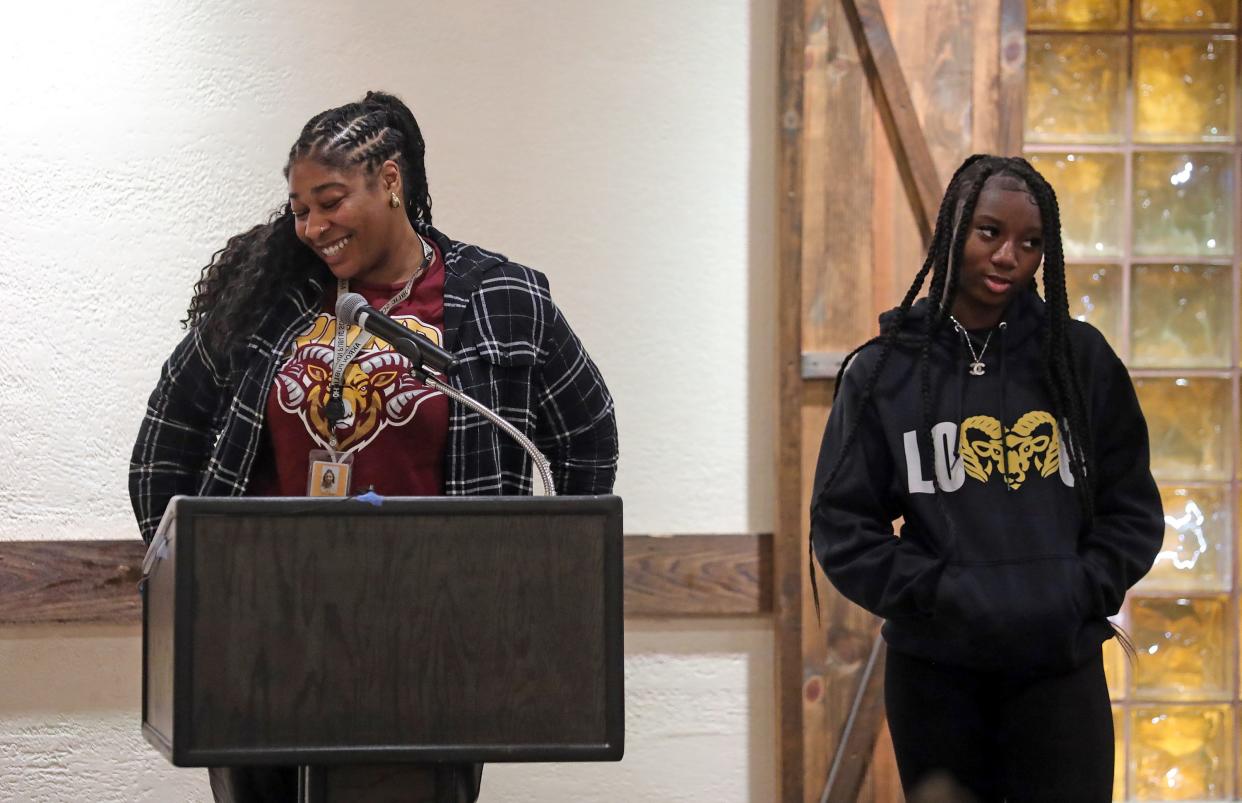Garfield girls basketball coach Paris Caldwell, left, smiles as she introduces Monikah Jordan during the Akron City Series high school basketball media day at Guy's Party Center on Tuesday in Akron.