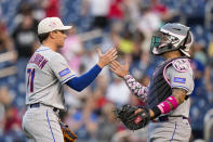 New York Mets relief pitcher Zach Muchkenhirn, left, celebrates with catcher Francisco Alvarez after a baseball game against the Washington Nationals at Nationals Park, Sunday, May 14, 2023, in Washington. The Mets won 8-2. (AP Photo/Alex Brandon)