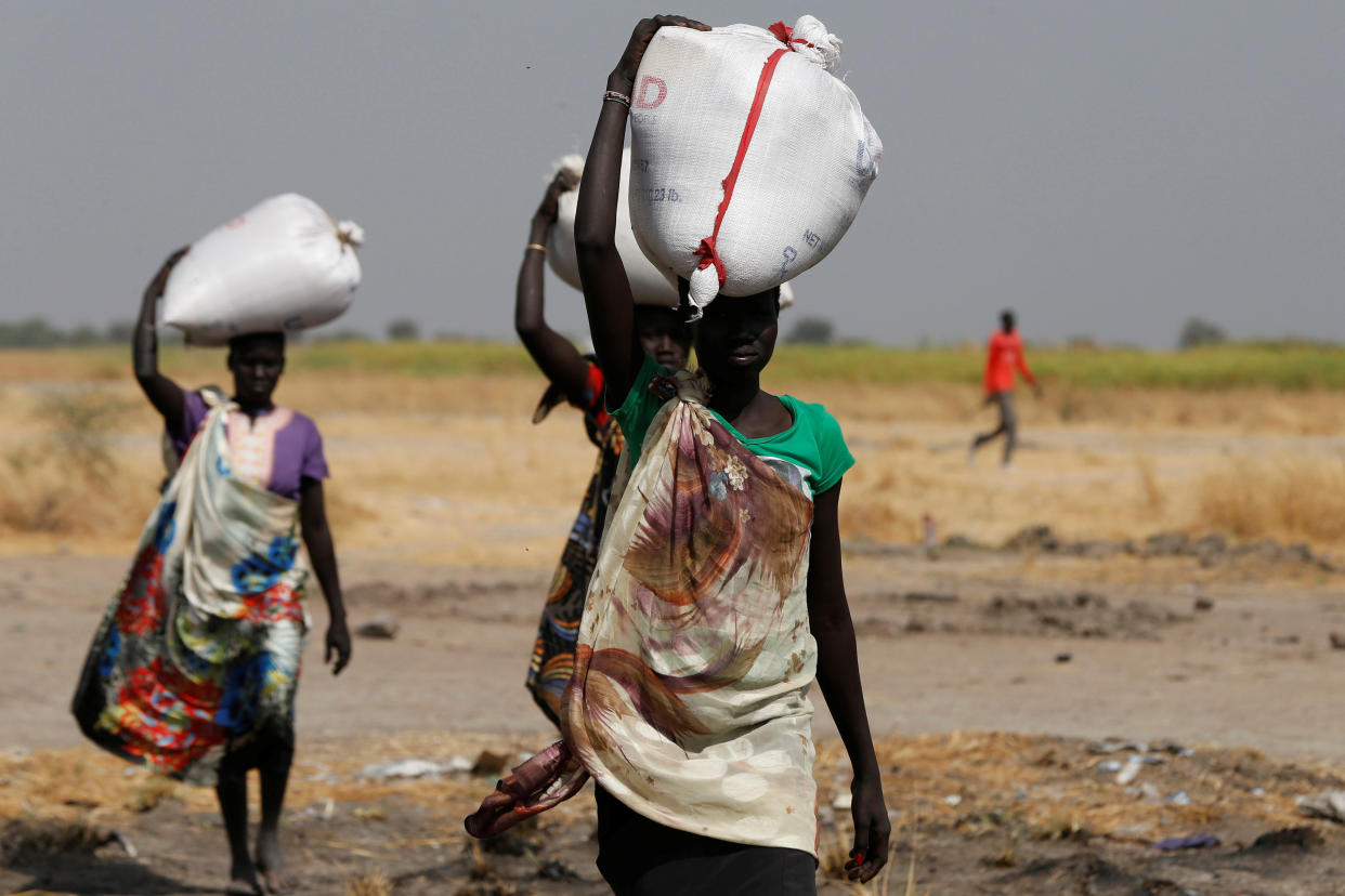 Women carry sacks of food in Nimini village, Unity State, in northern South Sudan, on Feb. 8, 2017. (Photo: Siegfried Modola/Reuters)