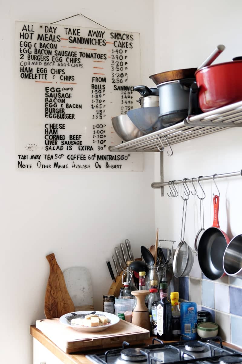 A small kitchen with a vintage diner sign