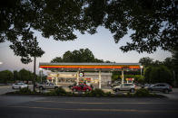 Drivers line up for fuel at a Shell Gas Station attached to Moore's Country Store on Boonsboro Road in Lynchburg, Va., Tuesday, May 11, 2021. More than 1,000 gas stations in the Southeast reported running out of fuel, primarily because of what analysts say is unwarranted panic-buying among drivers, as the shutdown of a major pipeline by hackers entered its fifth day. In response, Virginia Gov. Ralph Northam declared a state of emergency. (Kendall Warner/The News & Advance via AP)