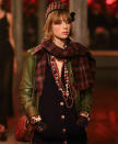 Edie Campbell took to the catwalk in a olive green jacket with tartan scarf and a matching pillbox hat.