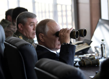 Russian President Vladimir Putin uses a pair of binoculars as he watches the Vostok-2018 (East-2018) war games at Tsugol military training ground in Zabaikalsky region, Russia, September 13, 2018. Sputnik/Alexei Nikolsky/Kremlin via REUTERS