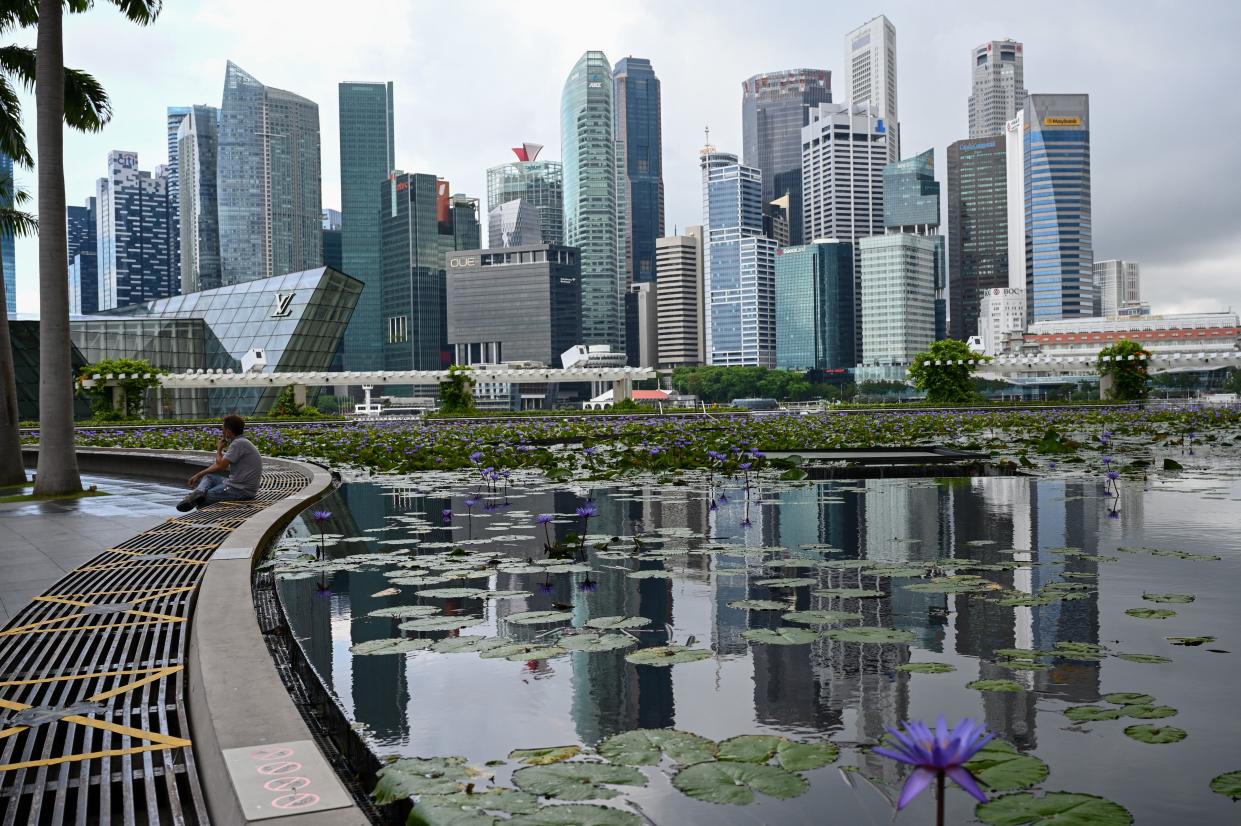 A man sits next the pond at Marina Bay Sands in Singapore on May 14, 2021, ahead of tightening restrictions over concerns of a rise in Covid-19 coronavirus cases. (Photo by Roslan Rahman / AFP) (Photo by ROSLAN RAHMAN/AFP via Getty Images)