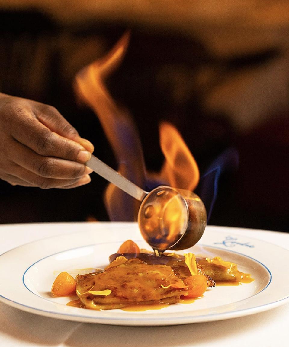 Grand Marnier is flambéed before being poured atop Crepes Suzette at La Goulue.