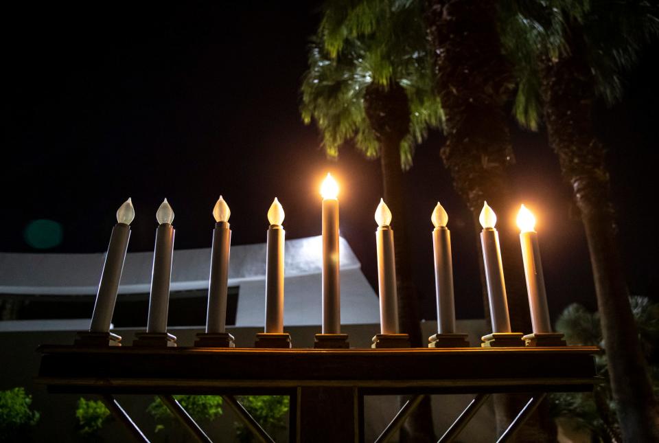 A large menorah is seen lit with the Shamash (the center candle) and the first candle lit during a Hanukkah celebration Thursday outside Temple Isaiah in Palm Springs.
