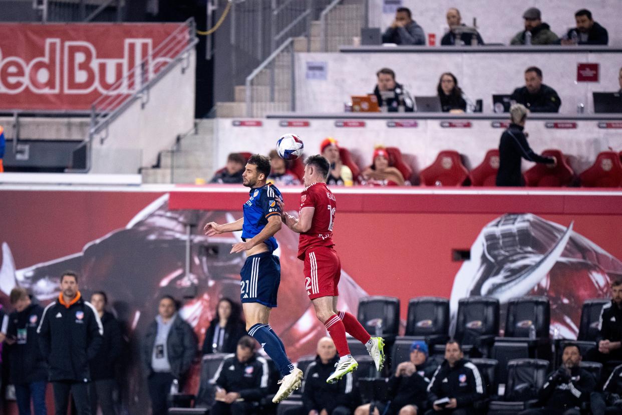 FC Cincinnati defender Matt Miazga (21) and New York Red Bulls defender Dylan Nealis (12) go to head the ball in the second half of the MLS playoff match between the New York Red Bulls and FC Cincinnati at Red Bull Arena in Harrison, N.J., on Saturday, Nov. 4, 2023.
