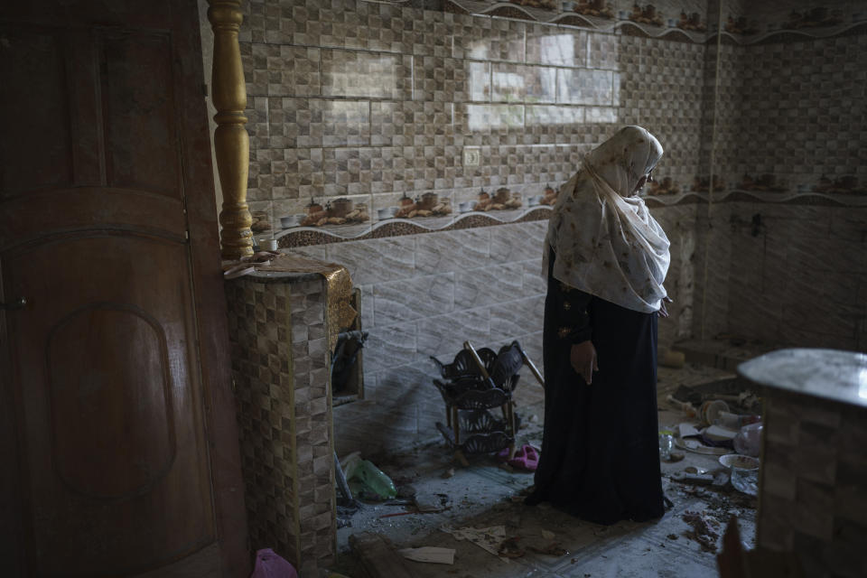 Khaldiya Nassir stands in her home, heavily damaged by airstrikes in the recent 11-day war in Beit Hanoun, northern Gaza Strip, Thursday, June 17, 2021. (AP Photo/Felipe Dana)