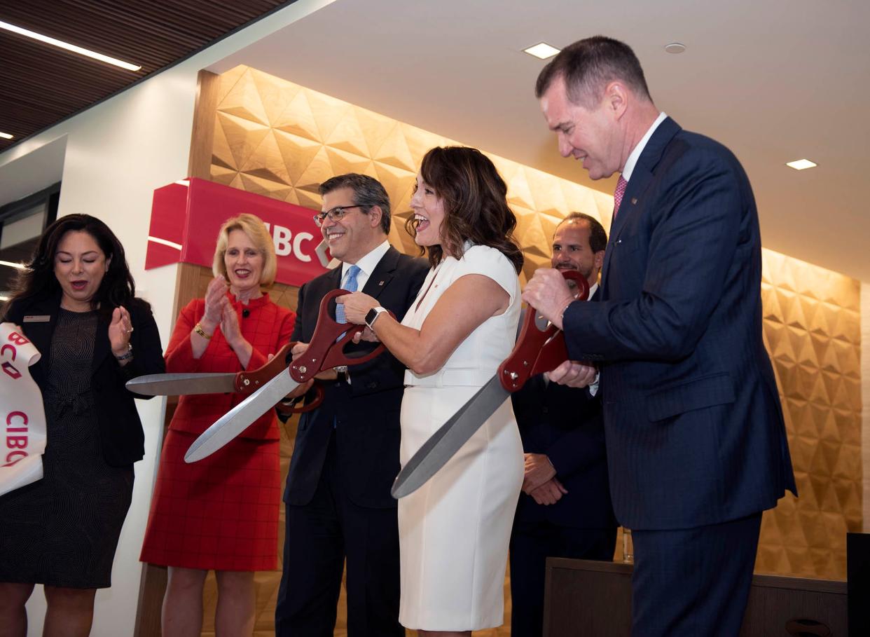 At center, from left to right: Canadian Imperial Bank of Commerce U.S. CEO Shawn Beber, CIBC Palm Beach Managing Director Gina Sabean, and CIBC U.S. head of private and personal banking Dan Sullivan Jr. host a ribbon-cutting ceremony Tuesday at the new CIBC branch at 340 Royal Palm Way.