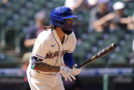 Seattle Mariners' J.P. Crawford watches the path of his two-run single against the Cleveland Indians in the third inning of a baseball game Sunday, May 16, 2021, in Seattle. (AP Photo/Elaine Thompson)