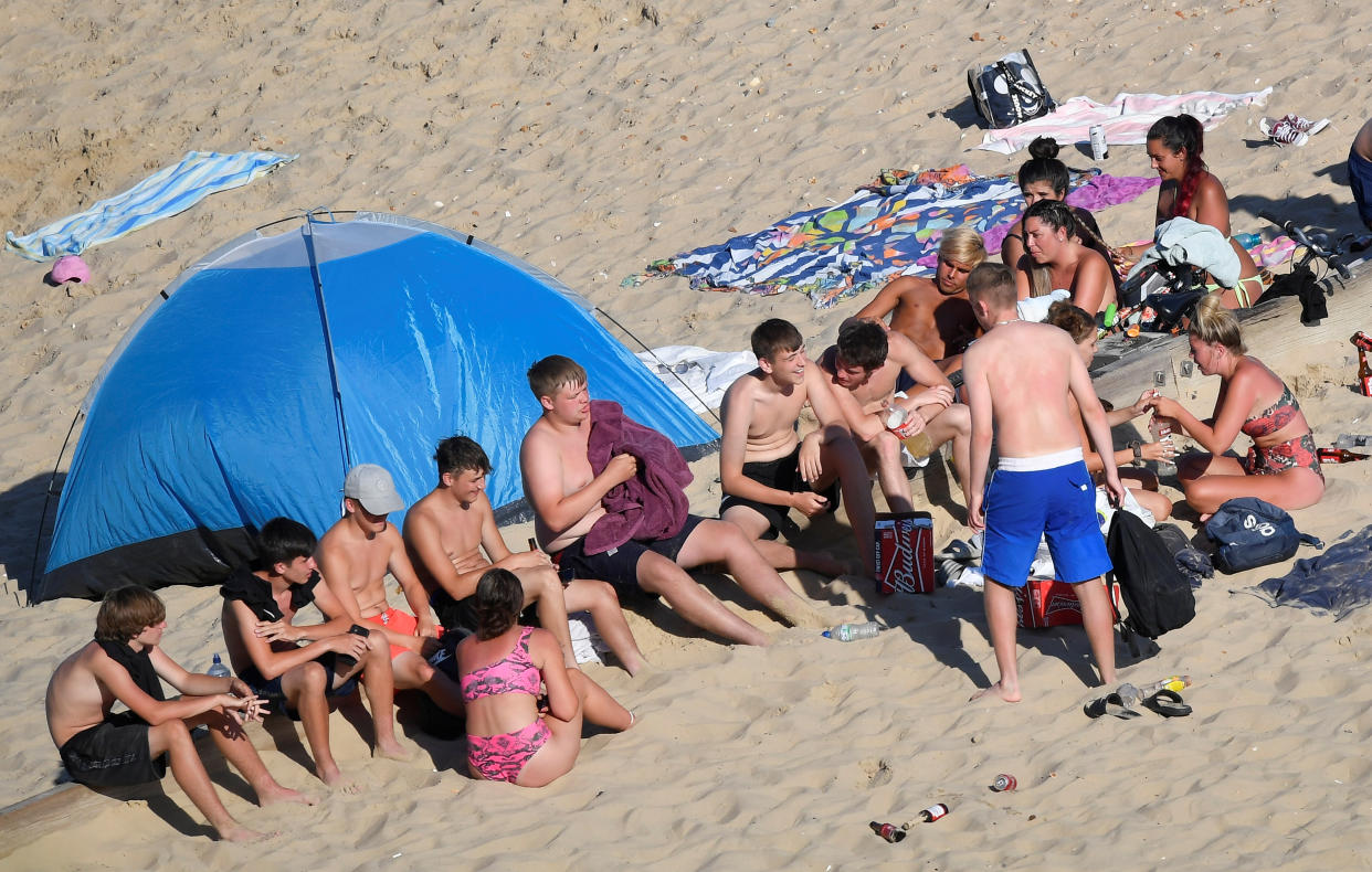 Groups of young people are seen on the beach in Bournemouth as they enjoy the hot weather after lockdown restrictions were eased following the outbreak of the coronavirus disease (COVID-19), Bournemouth, Britain, June 2, 2020. REUTERS/Toby Melville