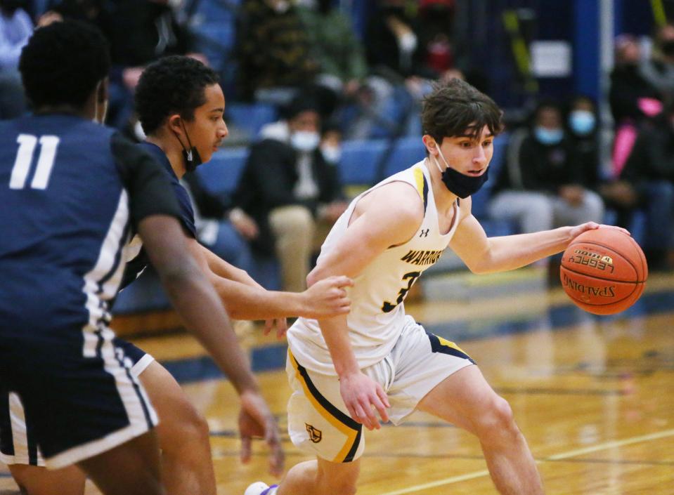 Lourdes' Cameron Crowley leads the ball away from Poughkeepsie's , from left, Dahomey Francis and Jalen Lee during Thursday's game in the Town of Poughkeepsie on January 20, 2022. 