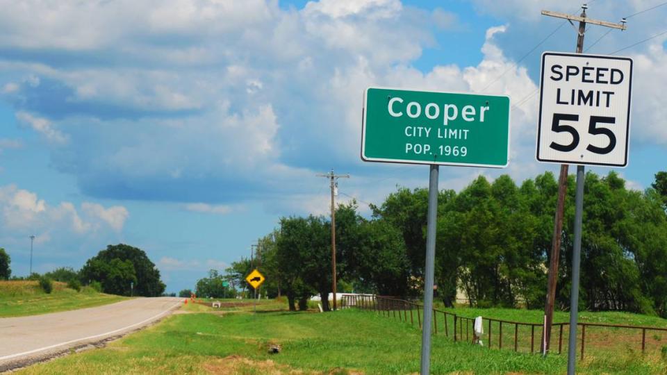 A sign along Farm to Market Road 64 marks the city limit of Cooper, Texas.