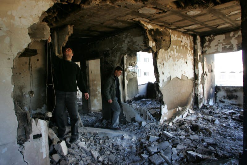 Palestinians search the rubble of destroyed houses on January 22, 2009, after a cease-fire between Israel and Gaza was called over the weekend after a 22-day Israeli offensive. On December 27, 2008, 225 people died when Israeli jets bombed Gaza in retaliation for Hamas-fired rockets, Israeli and Palestinian sources said. At least 300 people were injured. File Photo by Ismael Mohamad/UPI