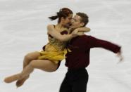 Emily Samuelson (L) and Evan Bates of the U.S. perform in the ice dance free dance figure skating event at the Vancouver Winter Olympics February 22, 2010. REUTERS/Gary Hershorn/File Photo