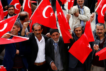 People wave Turkey's national flags during a rally organised by village guards in Cermik, a town in southeastern province of Diyarbakir, Turkey, March 10, 2017. Picture taken March 10, 2017. REUTERS/Umit Bektas