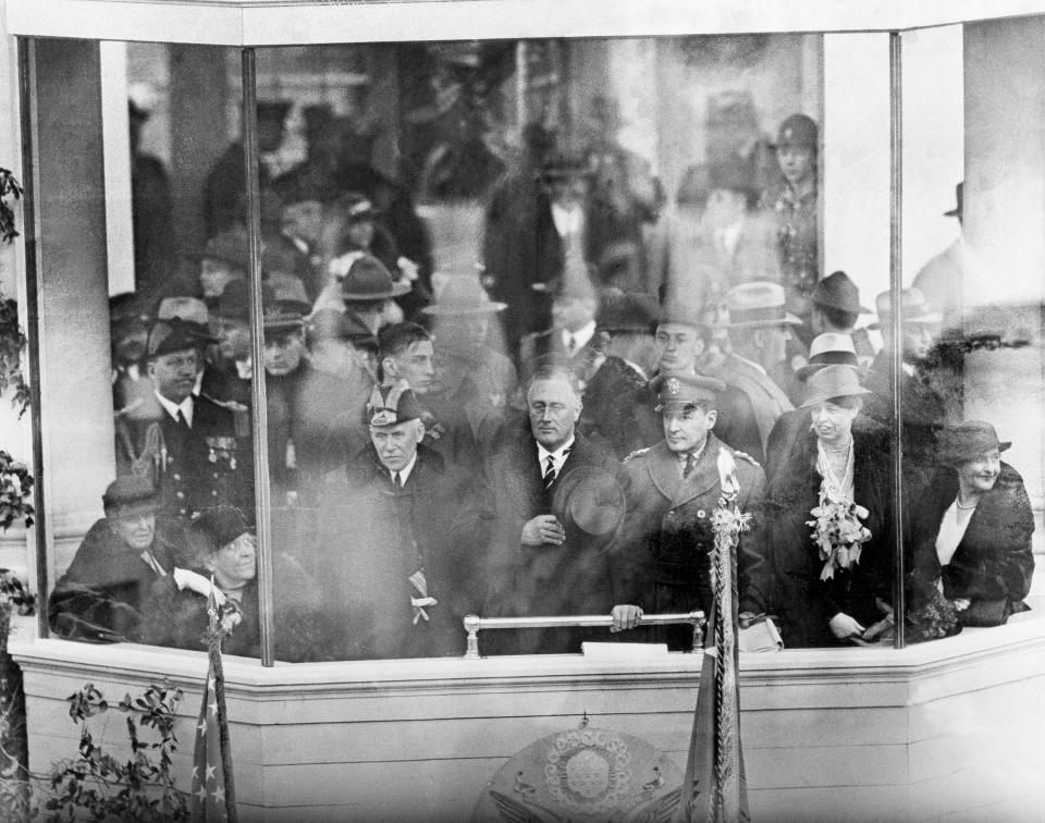 FILE - In this March 4, 1933, file photo President Franklin D. Roosevelt, center, watches his inaugural parade in Washington. Right of Roosevelt is Gen. Douglas MacArthur, Chief of Staff of the Army, and at the left, is Adm. William V. Pratt, Chief of Naval Operations. First lady Eleanor Roosevelt can be seen, second from right. Seated, at extreme left, is Sara Roosevelt, the president's mother, and between the new president and Gen. MacArthur is Anna Dall, daughter of the president. Roosevelt, elected in a landslide in 1932 amid the Great Depression, said in his first inaugural speech: “If I read the temper of our people correctly, we now realize as we have never realized before our interdependence on each other.” (AP Photo, File)