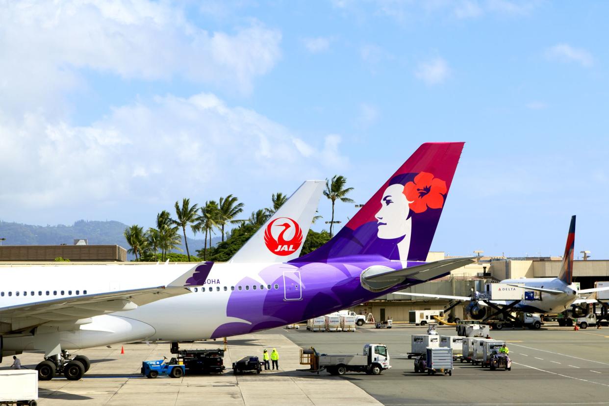Empennages of airplane of Hawaiian Airlines and Japan Airlines