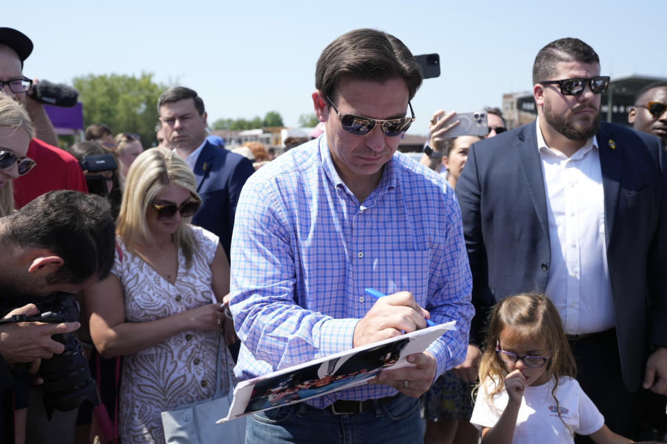 Republican presidential candidate Florida Gov. Ron DeSantis signs an autograph for a supporter at U.S. Sen. Joni Ernst's Roast and Ride, Saturday, June 3, 2023, in Des Moines, Iowa. (AP Photo/Charlie Neibergall)