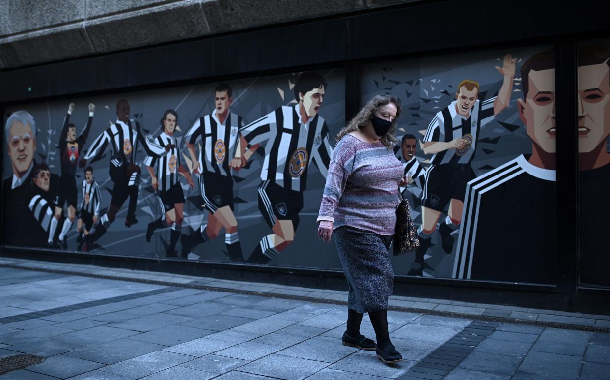 Woman wearing a face mask in Newcastle, where tighter regulations are coming in on 30 September (AFP via Getty Images)