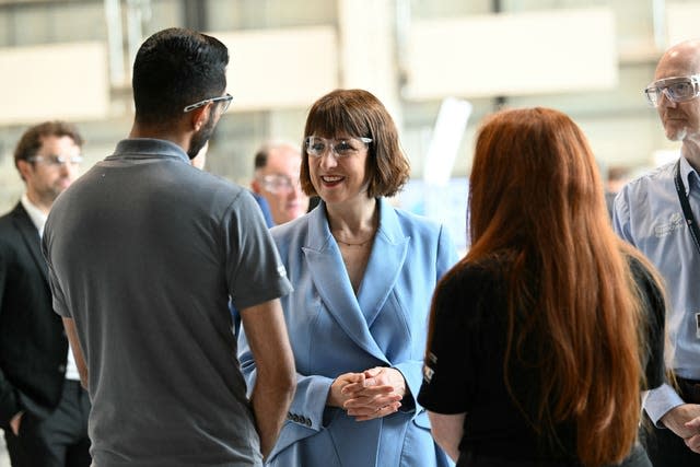 Rachel Reeves in safety goggles while talking to two people