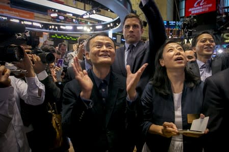 FILE PHOTO: Alibaba founder Jack Ma and CFO Maggie Wu react as the company's IPO begins trading at the NYSE in New York
