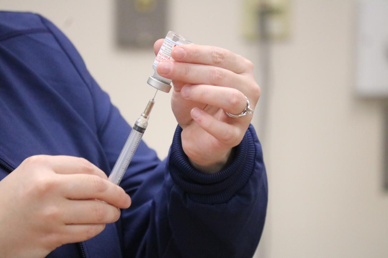 Katie Crowell, director of nursing at the Ottawa County Health Department, draws a dose of the COVID-19 vaccine.