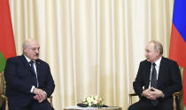 FILE - Russian President Vladimir Putin, right, and Belarusian President Alexander Lukashenko talk during their meeting at the Novo-Ogaryovo state residence, outside Moscow, Russia, Friday, Feb. 17, 2023. (Vladimir Astapkovich, Sputnik, Kremlin Pool Photo via AP, File)