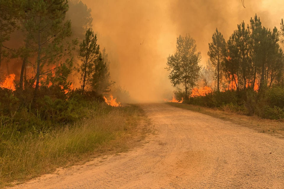 This photo provided by the fire brigade of the Gironde region (SDIS33) shows a wildfire near Landiras, southwestern France, Wednesday, July 13, 2022. More than 800 firefighters battled two wildfires in southwest France, according to the regional emergency service. The fires began Tuesday near the towns of Landiras and La Teste-de-Buch, and firefighters had not been able to contain them by Wednesday morning. Some 6,500 people have been evacuated from campgrounds and villages in the forested area. (SDIS33 via AP)