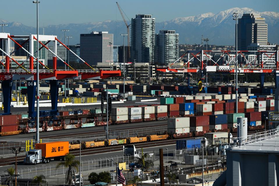 A truck carries a shipping container at the Port of Long Beach on January 11, 2022 in Long Beach, California. (Photo by Patrick T. FALLON / AFP) (Photo by PATRICK T. FALLON/AFP via Getty Images)