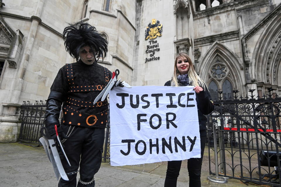 Supporters of actor Johnny Depp pose outside the High Court in London, Britain, March 18, 2021. REUTERS/Toby Melville     TPX IMAGES OF THE DAY. REFILE - CORRECTING YEAR