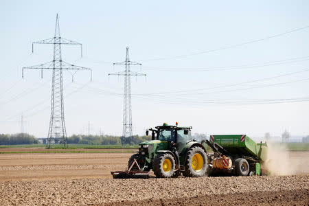 A tractor of the "Poschinger Bray'sche Gueterverwaltung" company equipped with an iTC receiver (used for parallel driving) plants potatoes at a field in Irlbach near Deggendorf, Germany, April 21, 2016. REUTERS/Michaela Rehle