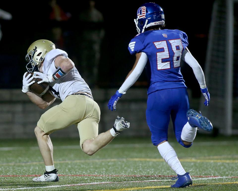 Hanover's Joe Curran makes the catch for the touchdown to give Hanover the 42-12 lead over Quincy during fourth quarter action of their game against Quincy at Veterans Memorial Stadium in Quincy on Friday, Oct. 7, 2022.