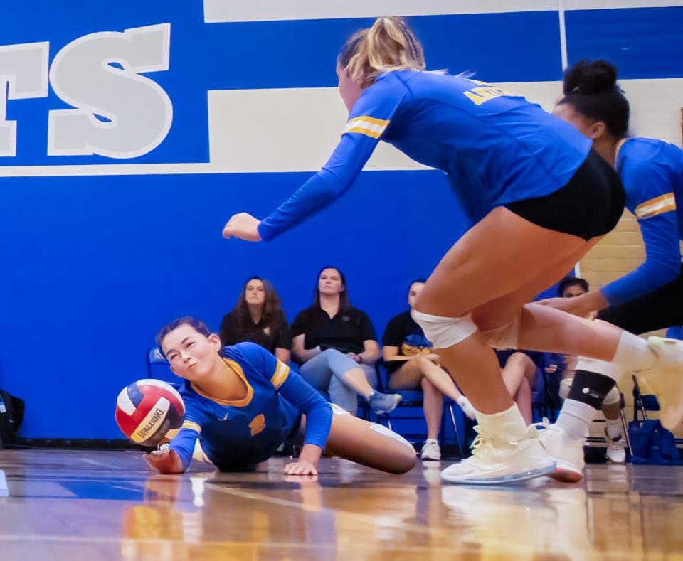 Anderson setter Maddie Stuesser dives for a dig during the second set of a nondistrict volleyball match Tuesday at McCallum. In a renewal of one of the city's fiercest rivalries, the Trojans beat the Knights in four sets.