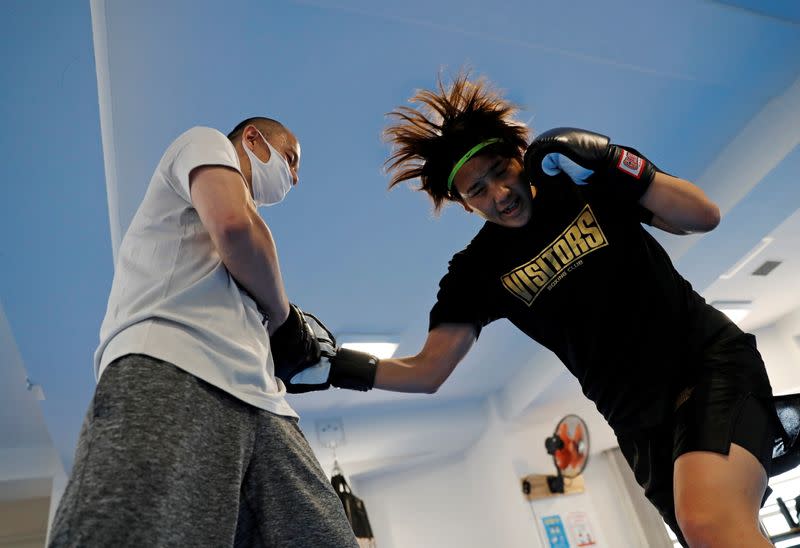 FILE PHOTO : Arisa Tsubata, a nurse and a boxer, practices with her work colleague Yuki Yamashita