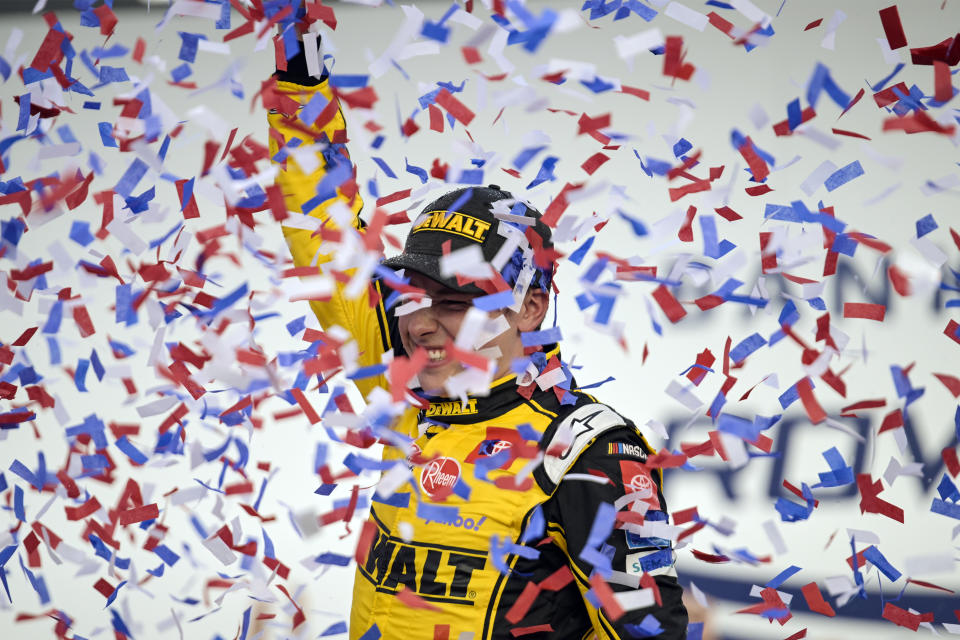 Christopher Bell celebrates in Victory Lane after winning a NASCAR Cup Series auto race at Charlotte Motor Speedway, Sunday, Oct. 9, 2022, in Concord, N.C. (AP Photo/Matt Kelley)