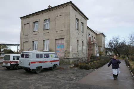 Doctor Nadiya Martynenko walks in front of the building of a clinic in the village of Staiky, south of Kiev, Ukraine, November 9, 2015. REUTERS/Valentyn Ogirenko